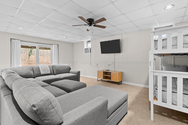 living room featuring recessed lighting, ceiling fan, a paneled ceiling, and baseboards