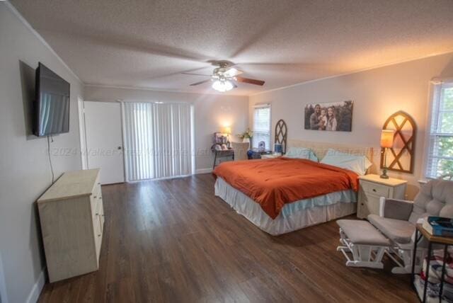 bedroom featuring ceiling fan, dark hardwood / wood-style floors, and a textured ceiling