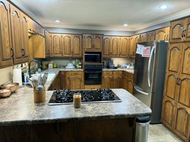 kitchen with black appliances, sink, and crown molding