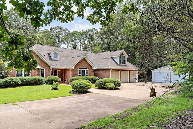 cape cod home featuring a garage and a front lawn