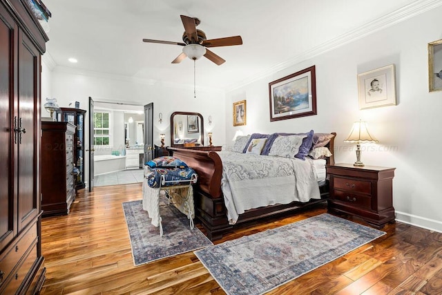 bedroom featuring dark hardwood / wood-style flooring, ensuite bathroom, ceiling fan, and ornamental molding