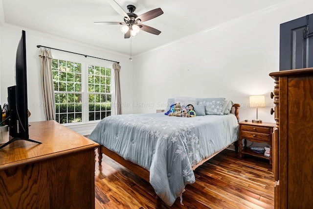 bedroom featuring ceiling fan, dark hardwood / wood-style flooring, and ornamental molding