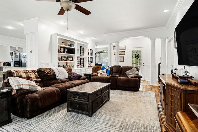 living room featuring crown molding, light hardwood / wood-style flooring, and ceiling fan