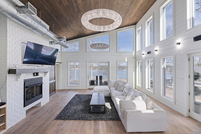 living area featuring wood finished floors, wooden ceiling, and a fireplace