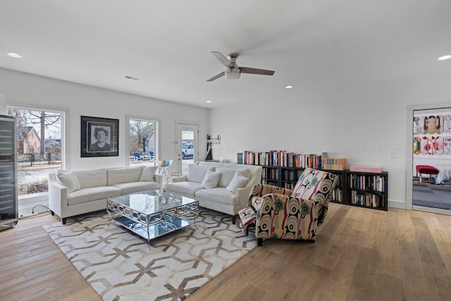 living room with recessed lighting, visible vents, ceiling fan, and hardwood / wood-style floors