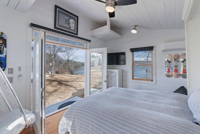 bedroom featuring access to exterior, vaulted ceiling, wood finished floors, wooden ceiling, and a wall mounted air conditioner