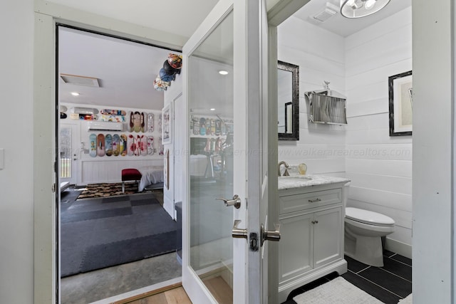 bathroom with toilet, ensuite bathroom, and vanity