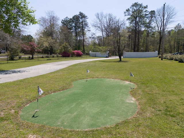 surrounding community featuring a lawn and fence