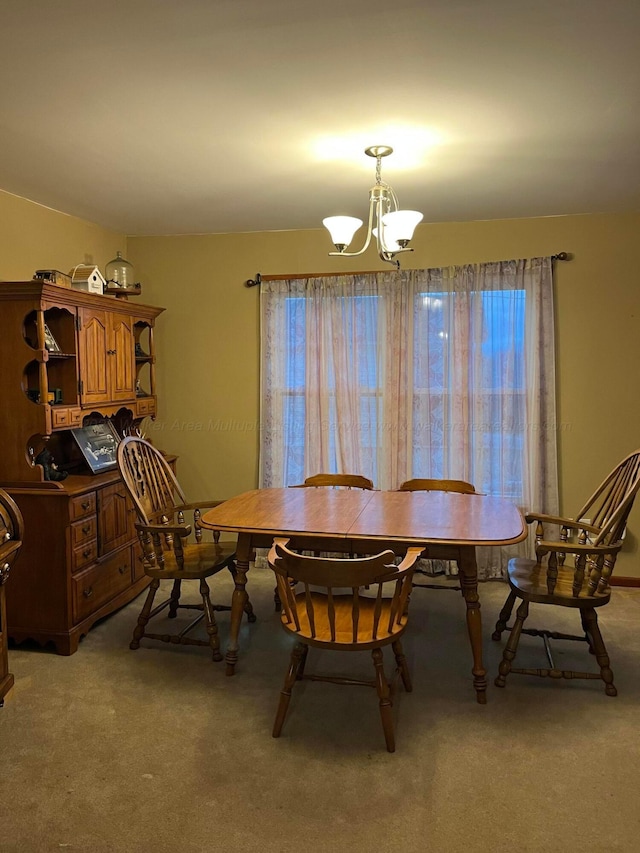 dining room featuring light carpet and an inviting chandelier