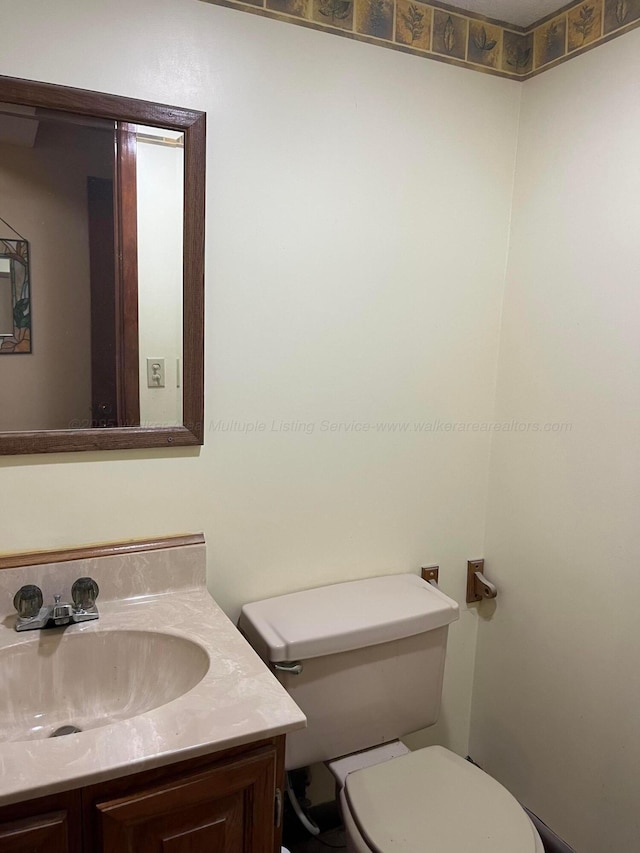 bathroom with toilet and vanity