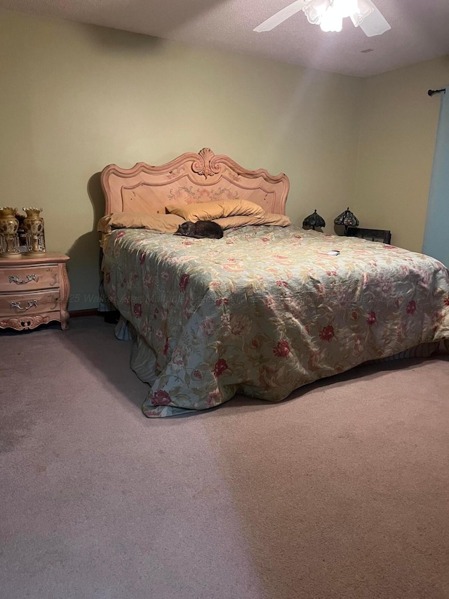 bedroom with ceiling fan and carpet floors