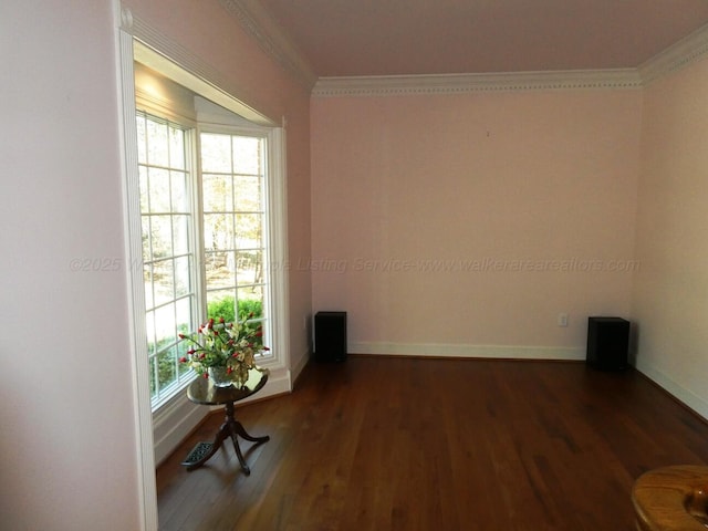 empty room with crown molding and dark hardwood / wood-style floors