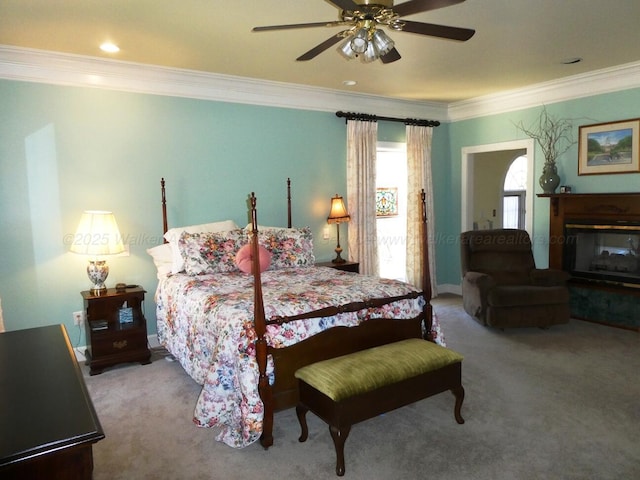 bedroom with crown molding, light colored carpet, and ceiling fan