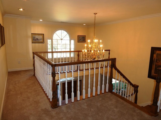 stairs with a notable chandelier, ornamental molding, and carpet