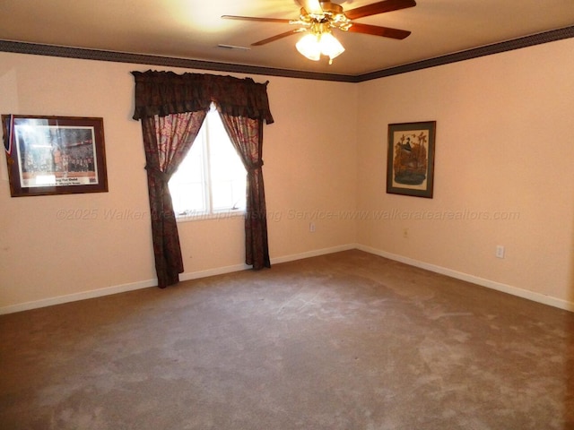 unfurnished room featuring ceiling fan, ornamental molding, and carpet