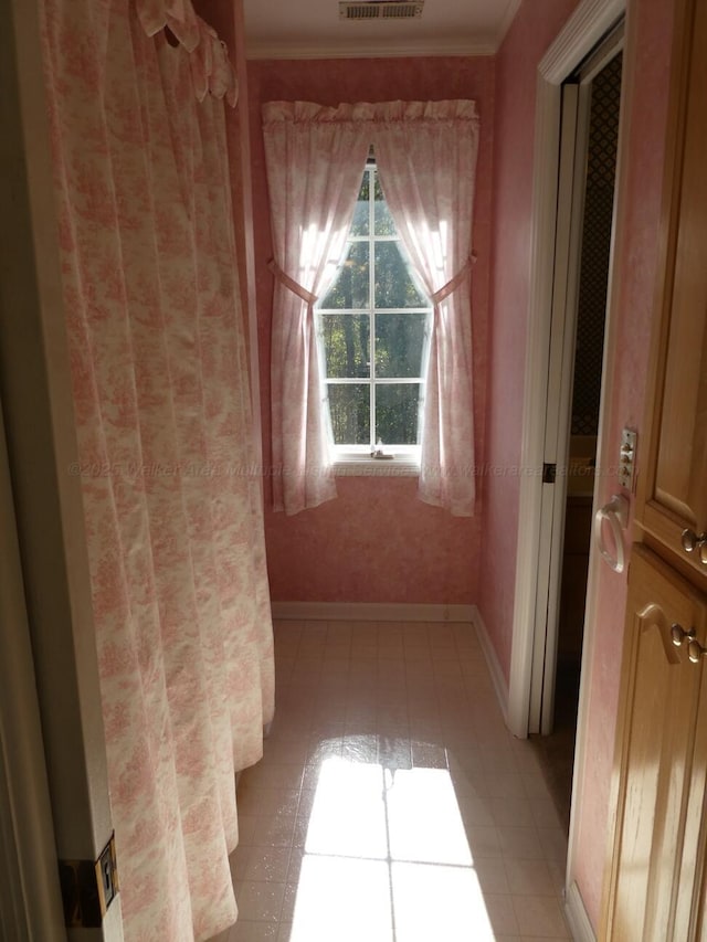 corridor featuring ornamental molding