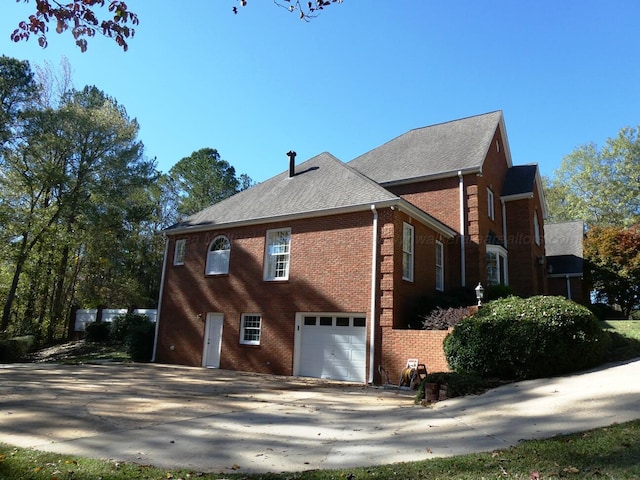 view of side of home with a garage