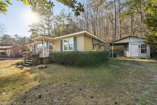 view of home's exterior with a lawn and a storage unit