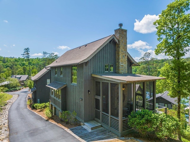 view of home's exterior with a sunroom