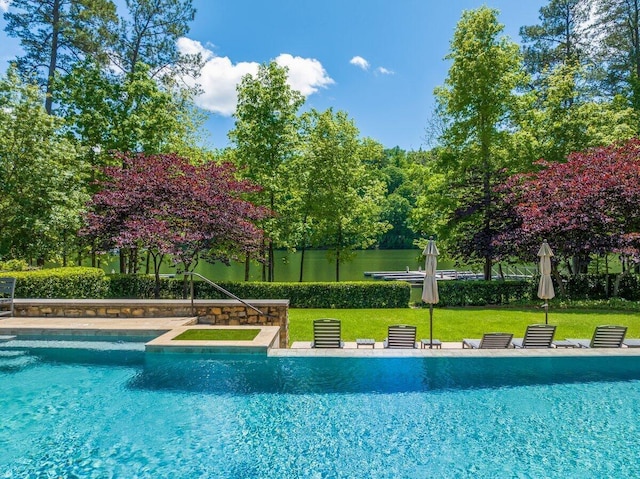 view of swimming pool featuring a yard and central air condition unit