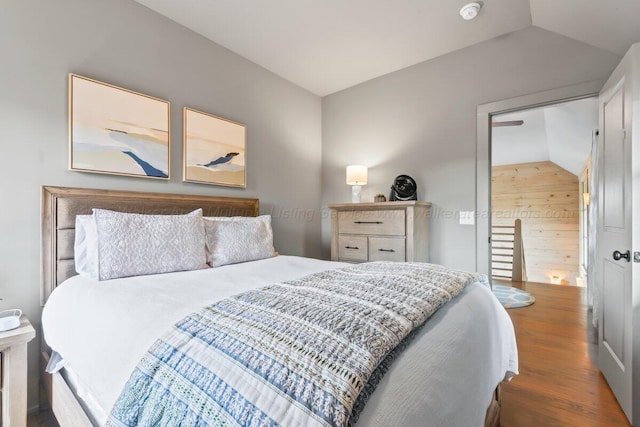 bedroom featuring lofted ceiling and dark wood-type flooring