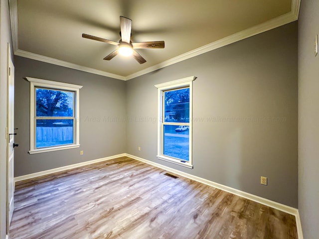 spare room with ceiling fan, light hardwood / wood-style flooring, and ornamental molding