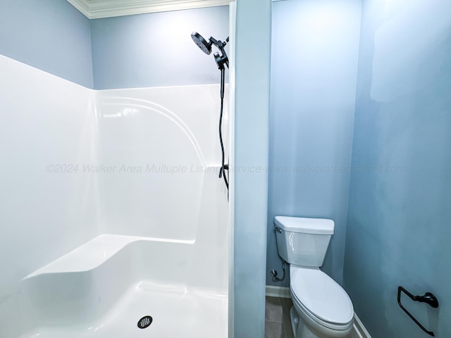 bathroom with tile patterned floors, toilet, and ornamental molding