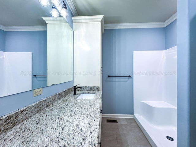 bathroom featuring tile patterned floors, vanity, ornamental molding, and walk in shower