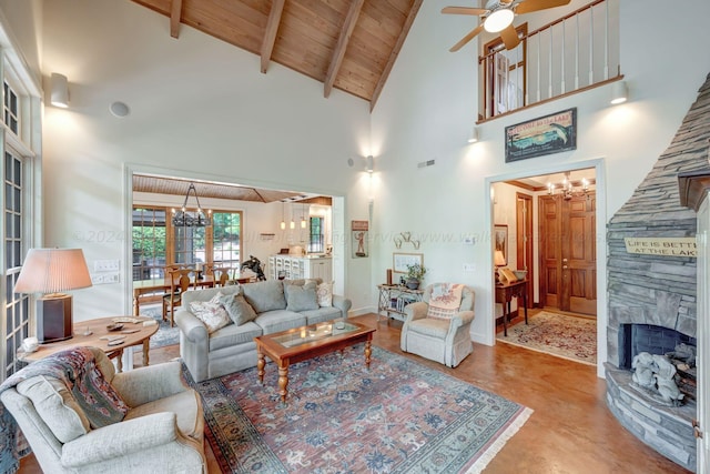 living room featuring wood ceiling, high vaulted ceiling, a fireplace, ceiling fan with notable chandelier, and beamed ceiling