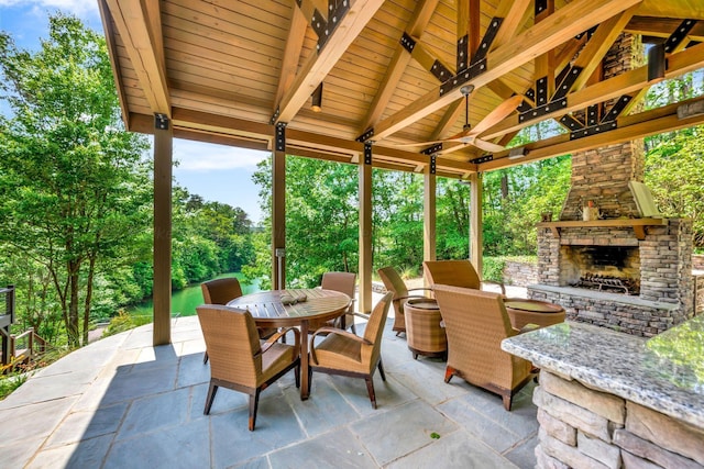 view of patio / terrace with a gazebo and an outdoor stone fireplace