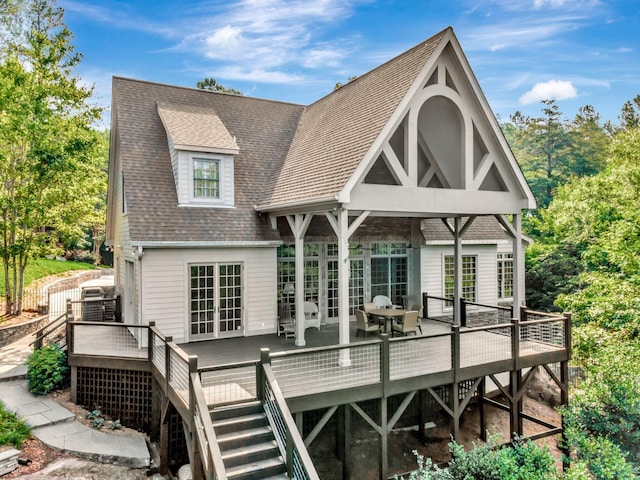 back of house with a wooden deck and french doors