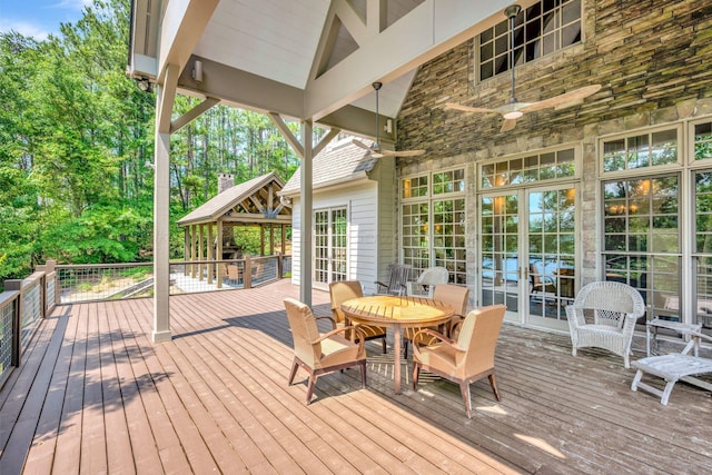 wooden terrace featuring a gazebo, french doors, and ceiling fan