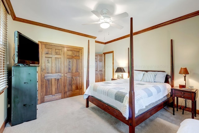 carpeted bedroom with ornamental molding, a closet, and ceiling fan