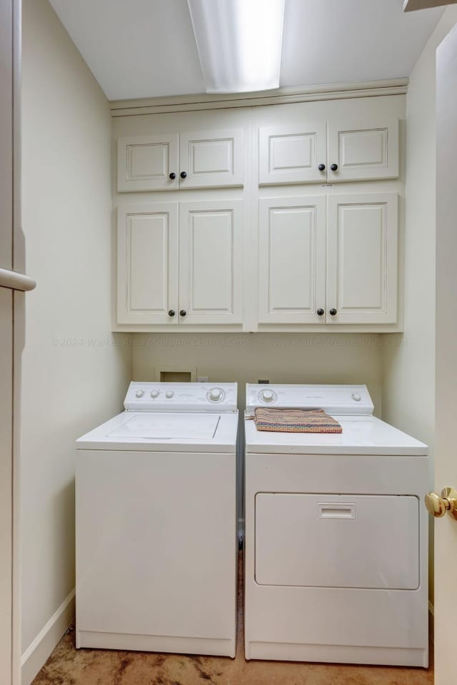 laundry area featuring cabinets and washing machine and dryer