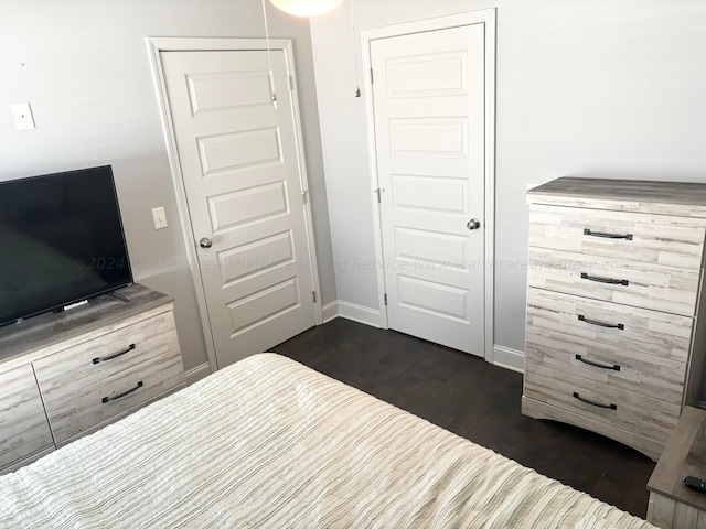 bedroom featuring dark hardwood / wood-style flooring and a closet