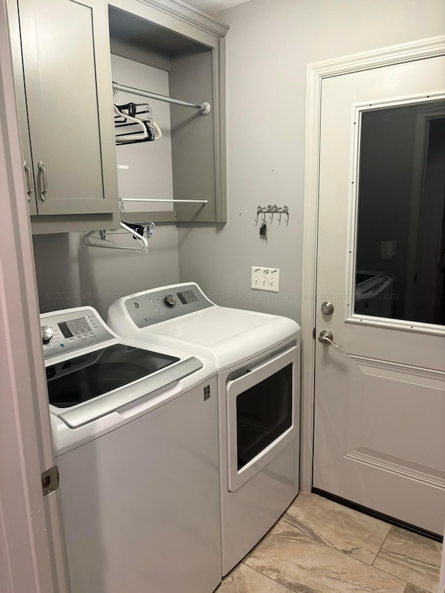 washroom featuring cabinets and independent washer and dryer