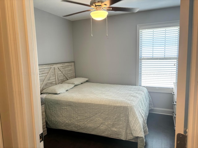 bedroom with ceiling fan and dark wood-type flooring