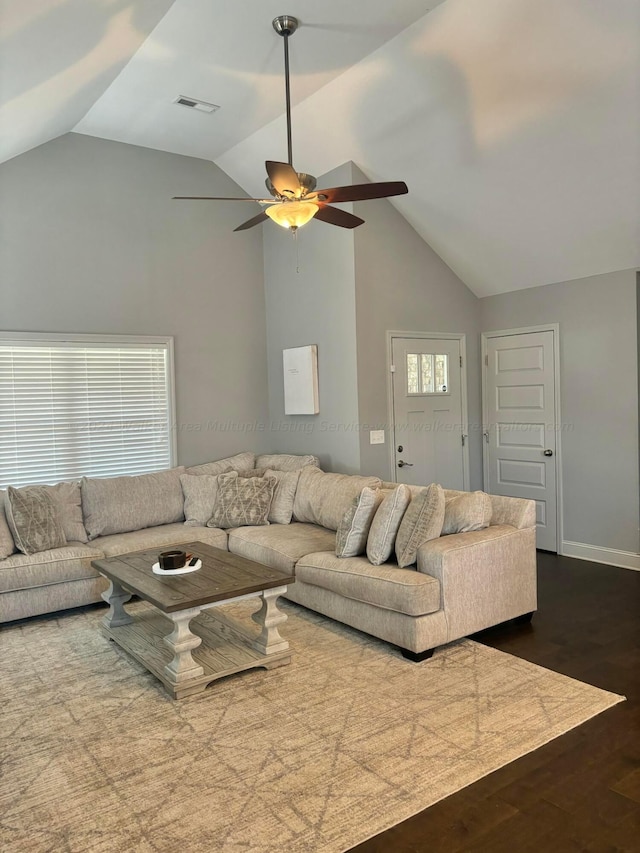 living room with ceiling fan, dark hardwood / wood-style flooring, and lofted ceiling