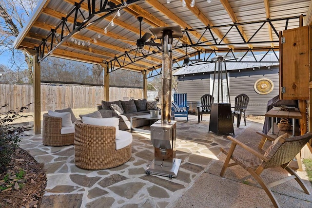 view of patio with an outdoor hangout area and fence