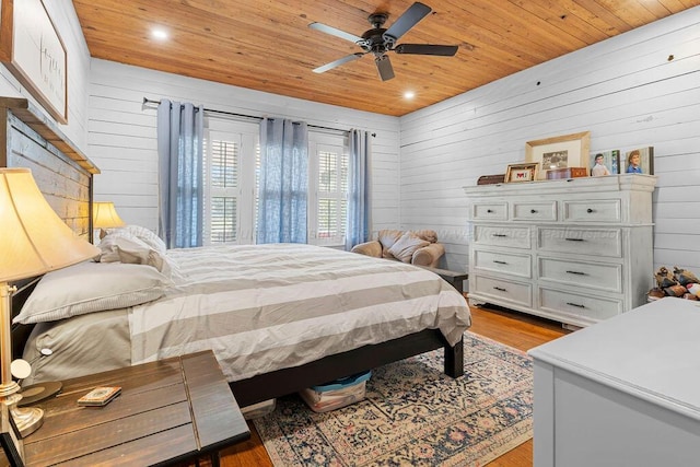 bedroom with ceiling fan, wood walls, wood ceiling, recessed lighting, and light wood-style flooring