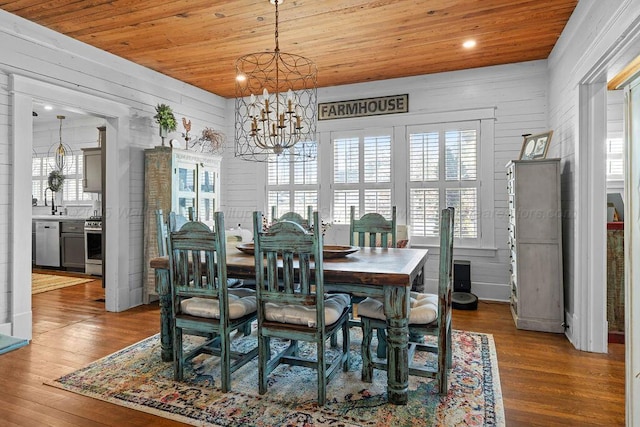 dining space with an inviting chandelier, recessed lighting, wood finished floors, and wooden ceiling