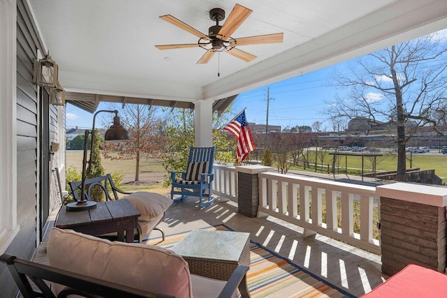 deck featuring covered porch and ceiling fan