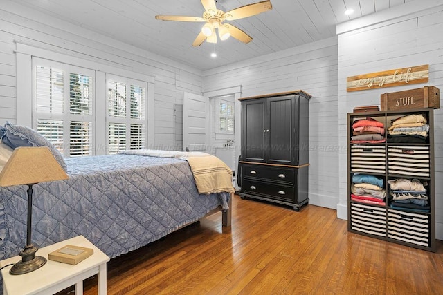 bedroom with wooden walls, ceiling fan, recessed lighting, wooden ceiling, and wood finished floors