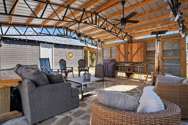 view of patio / terrace featuring an outdoor structure, a grill, and an outdoor hangout area