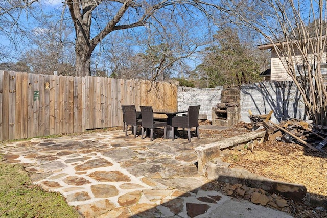 view of patio featuring outdoor dining area and fence