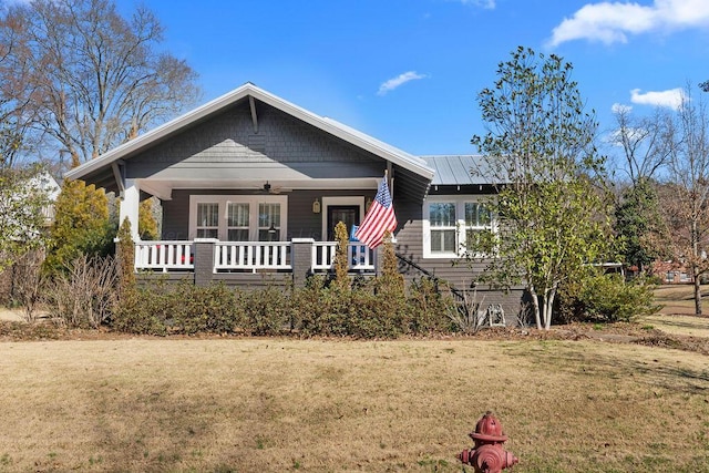 view of front of home featuring metal roof, a porch, ceiling fan, and a front yard