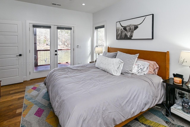 bedroom featuring access to exterior, dark wood-type flooring, and french doors