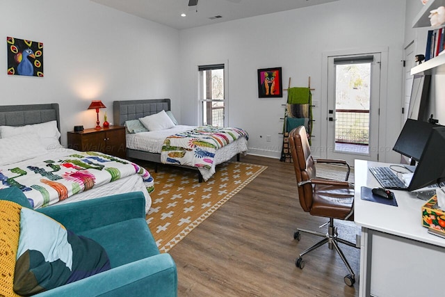 bedroom with access to outside, multiple windows, ceiling fan, and dark wood-type flooring