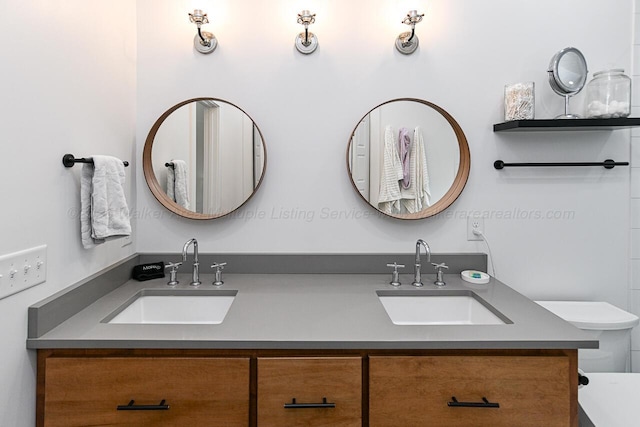 bathroom featuring vanity and toilet