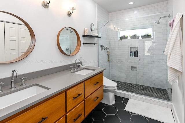 bathroom with tile patterned flooring, vanity, toilet, and walk in shower